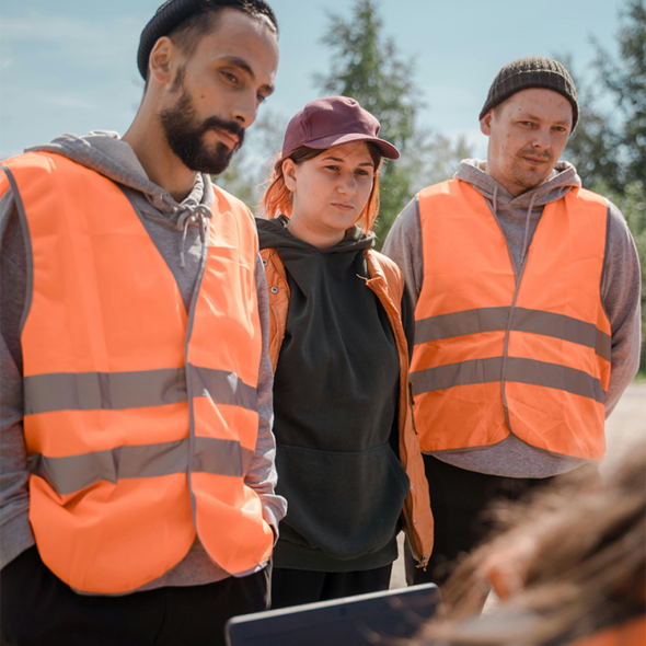 Young Canadian construction workers discussing work opportunities representing local hiring efforts for LMIA job advertising in Canada
