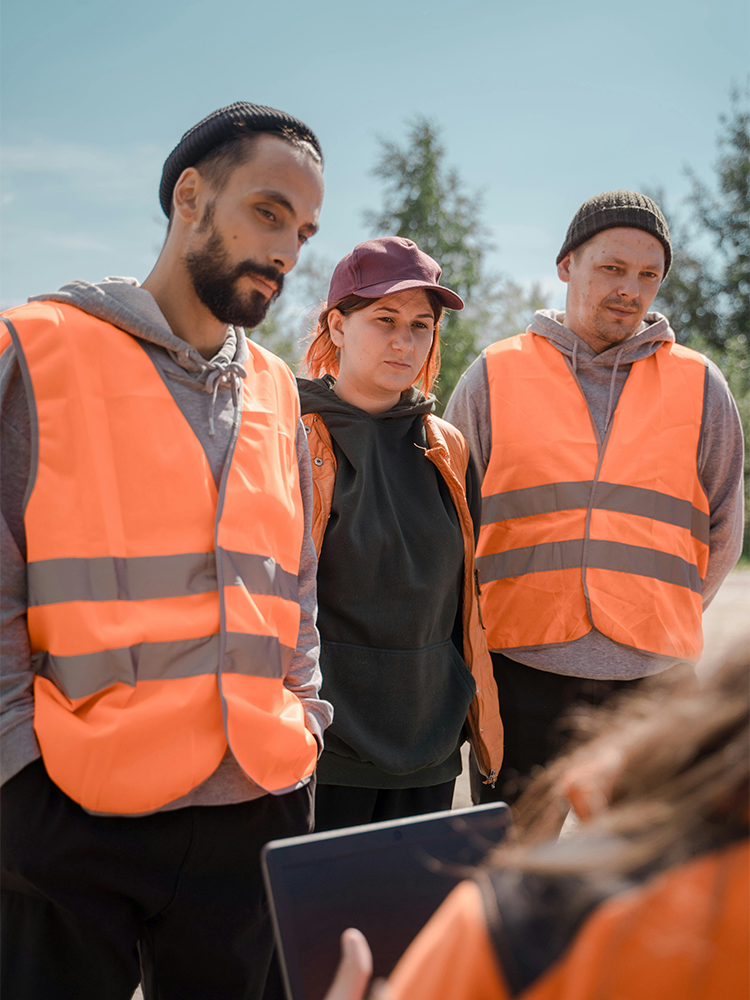 Young Canadian construction workers discussing work opportunities representing local hiring efforts for LMIA job advertising in Canada