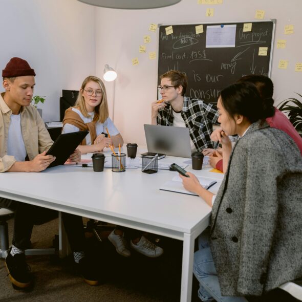 Young Canadian job seekers discussing work opportunities as part of LMIA job advertising in Canada
